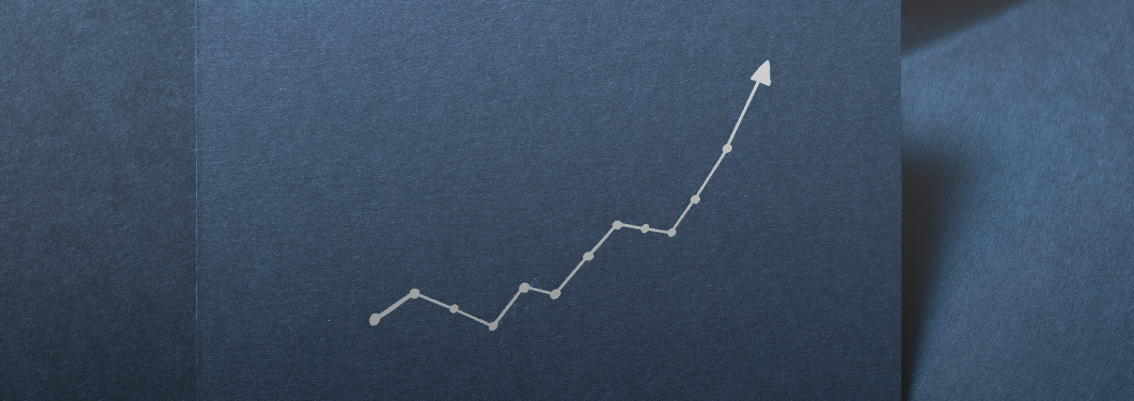 A dark blue business card with a line graph arrow showing an upward trend.