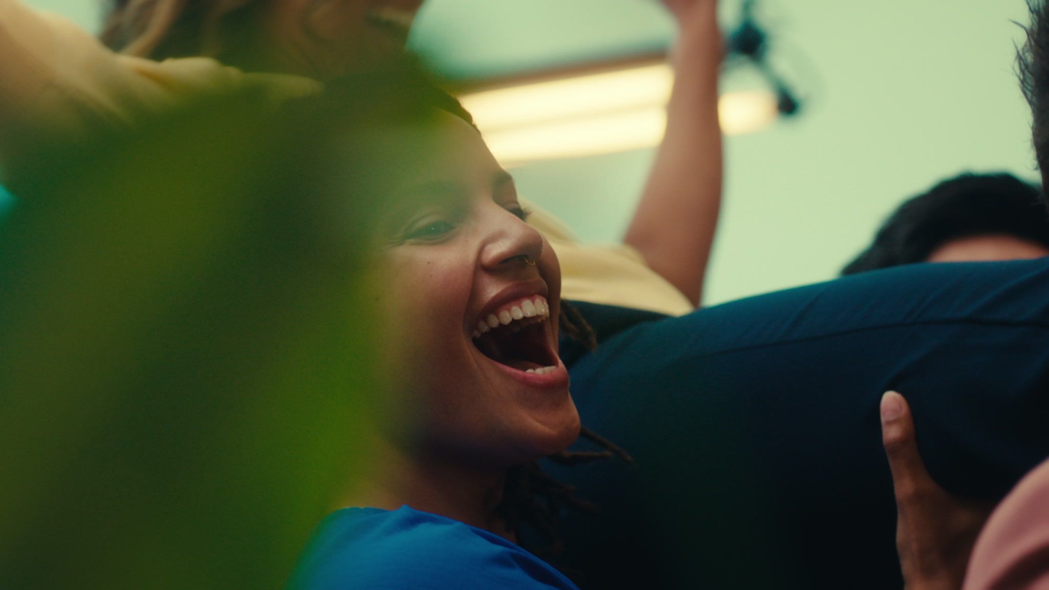 Happy entrepreneurs giving eachother high-five on the shoulders of colleagues