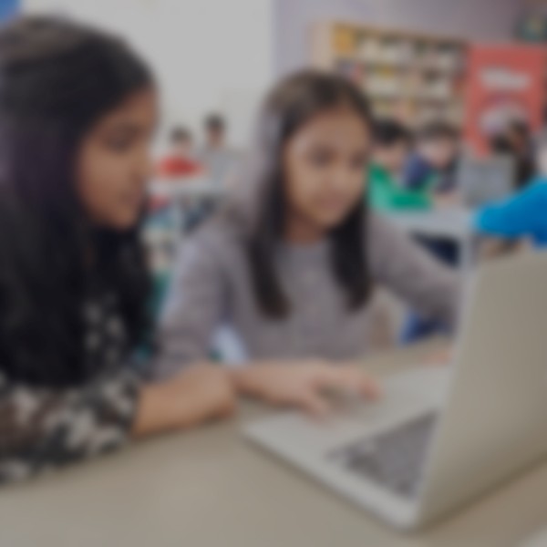 Little girls learning how to code on a portable computer