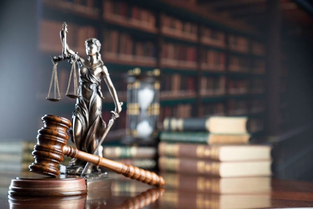 Image Small personal injury law firm concept with gavel and Lady Justice statue on a desk in a law office.