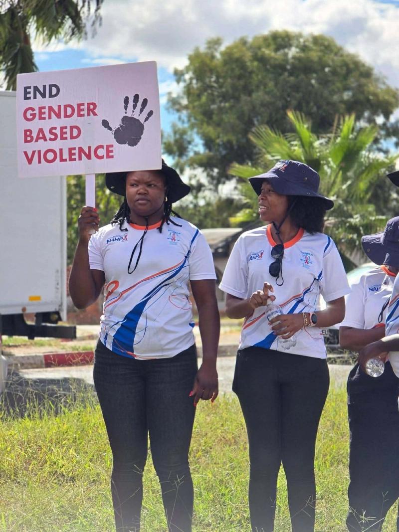 A Re A Bua Foundation member in a branded t-shirt speaks at the march.