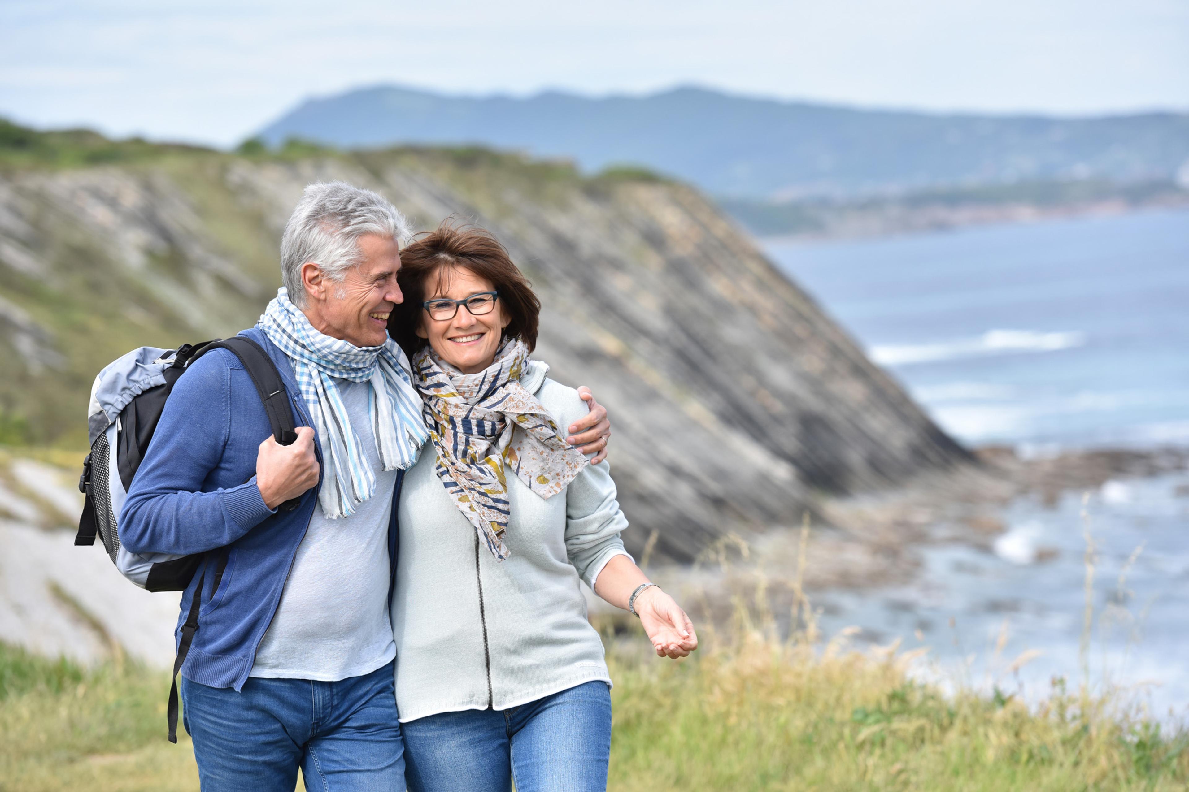 Elderly couple enjoying free time on a coastal walk
