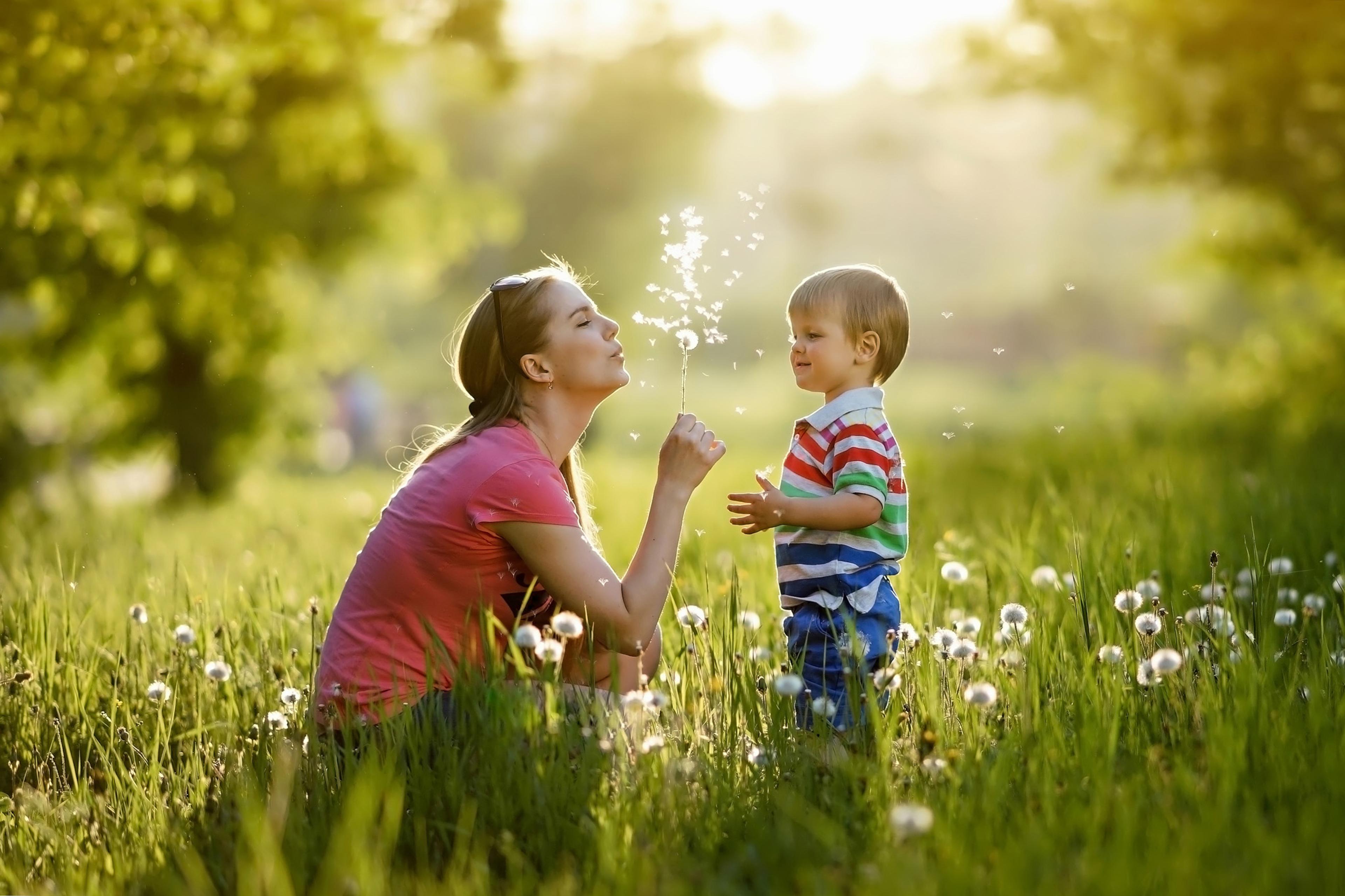Mother and child picking flowers in a meadow