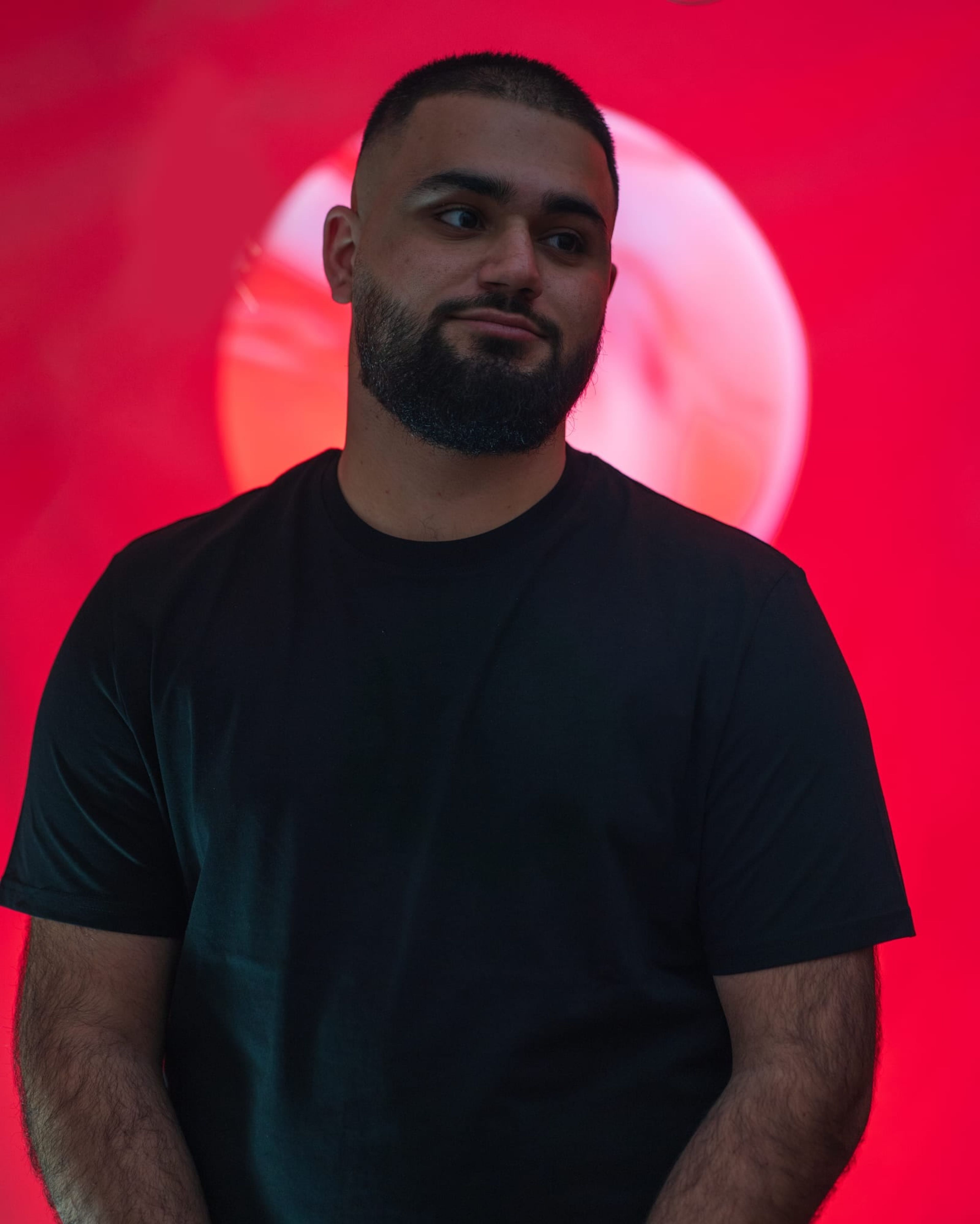Personal branding portrait in front of a red circle of light