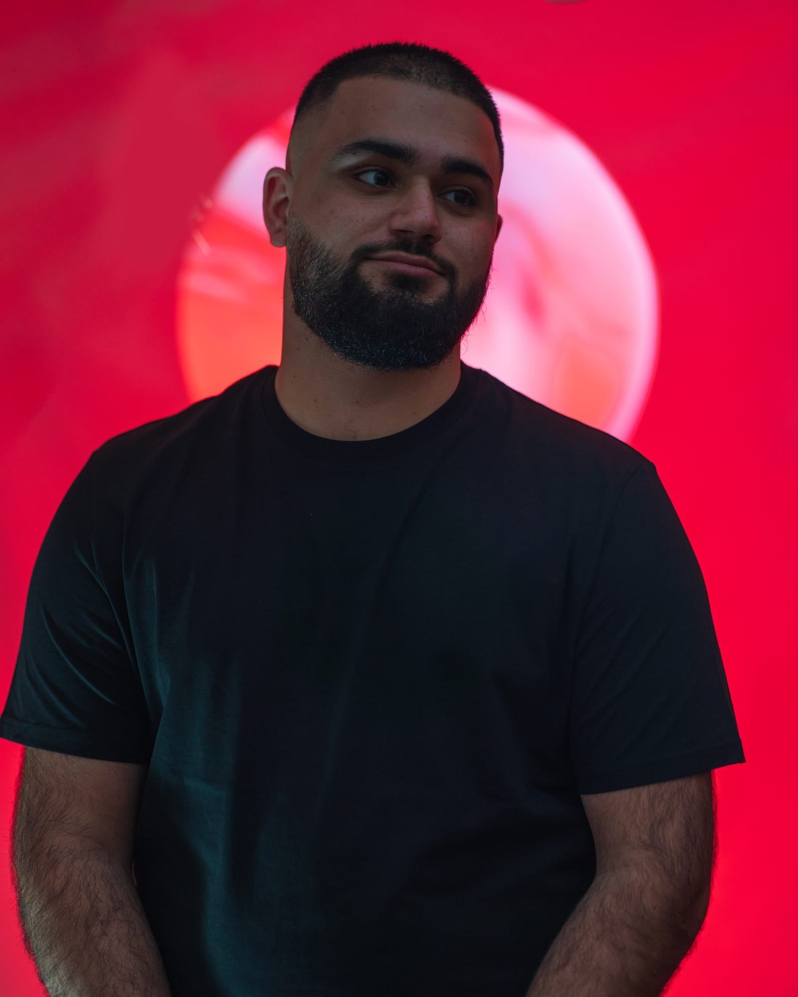 Personal branding portrait in front of a red circle of light