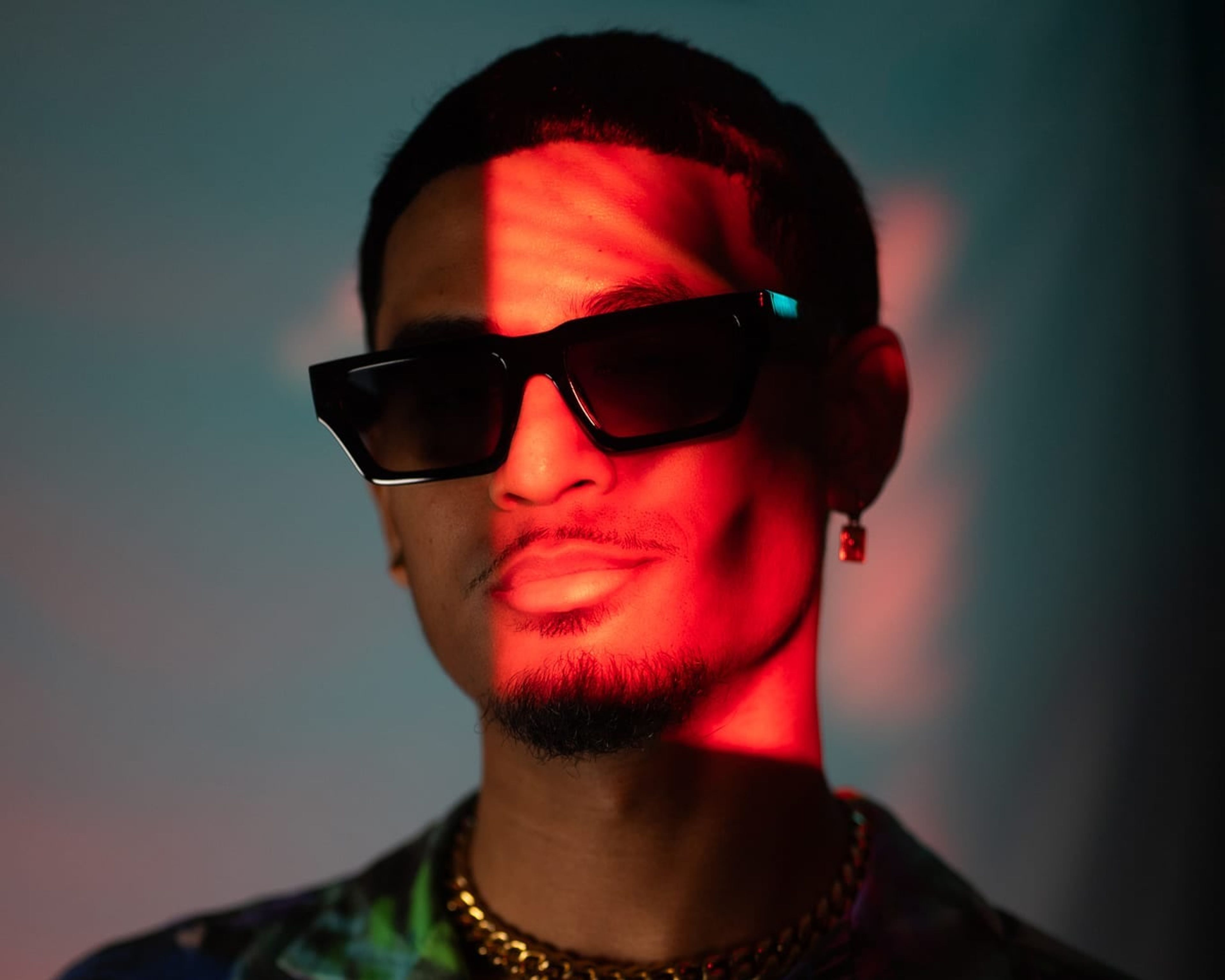 Personal branding portrait with sunglasses, a red light streak and a colourful shirt