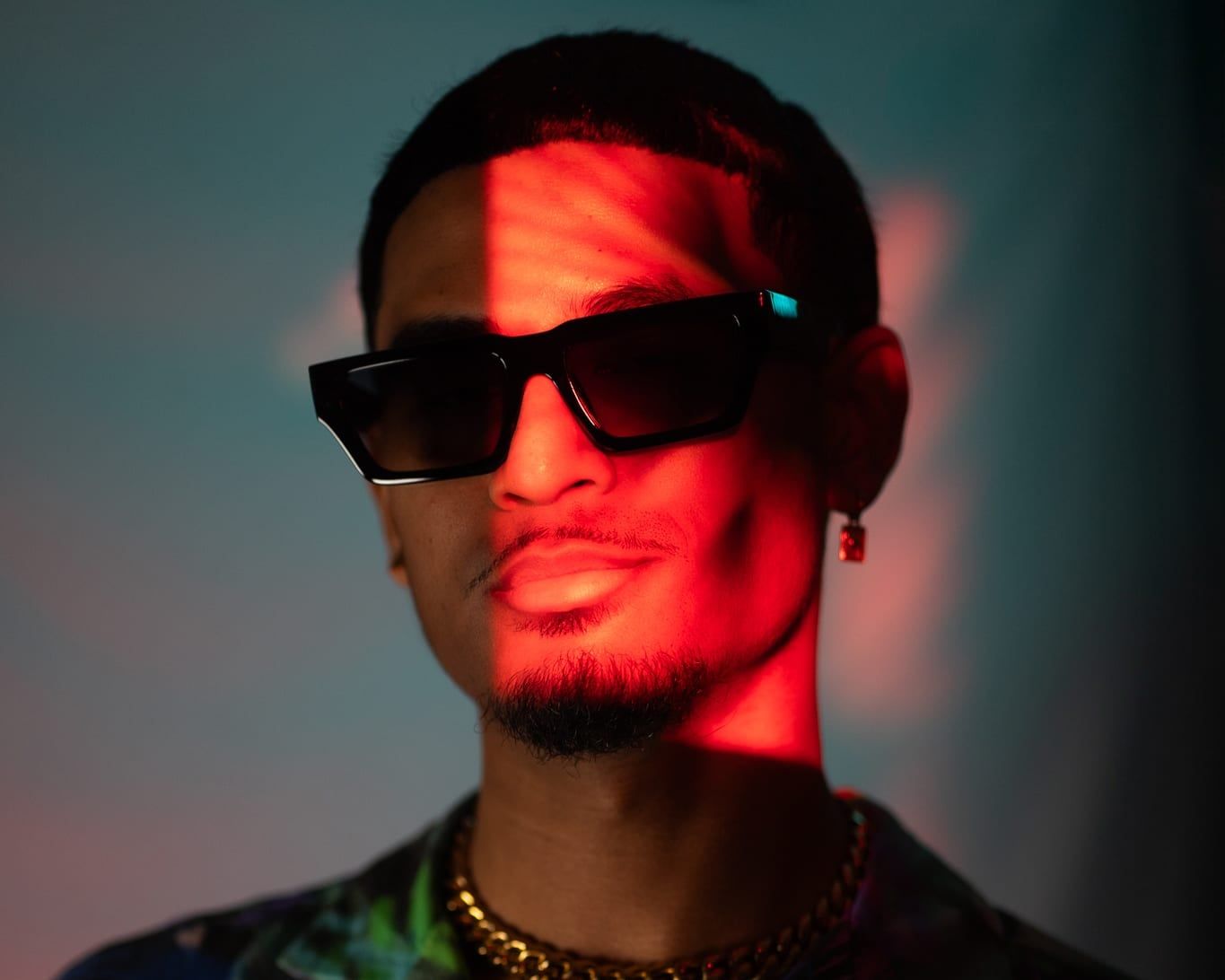 Personal branding portrait with sunglasses, a red light streak and a colourful shirt