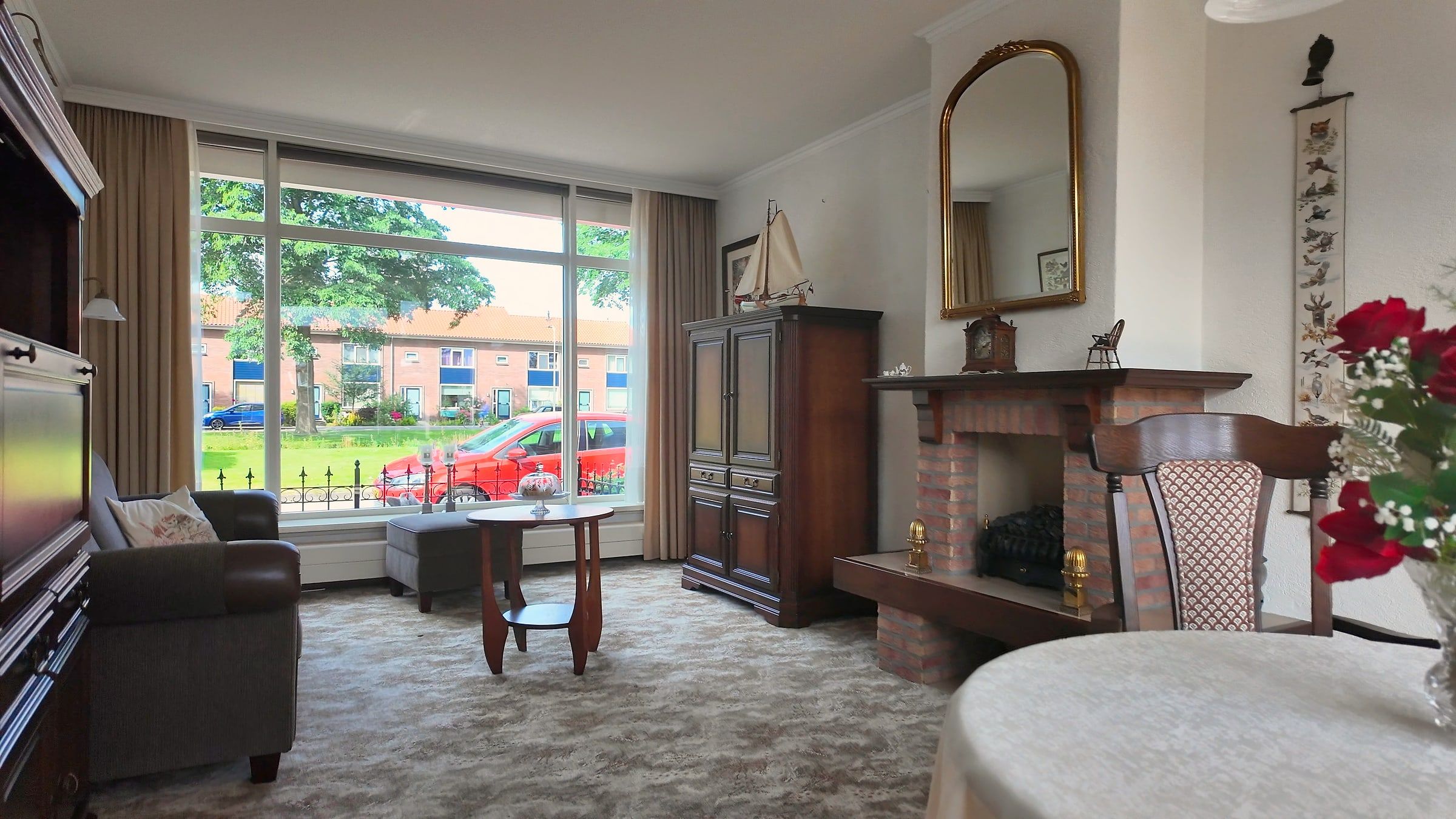 Classically furnished living room with fireplace
