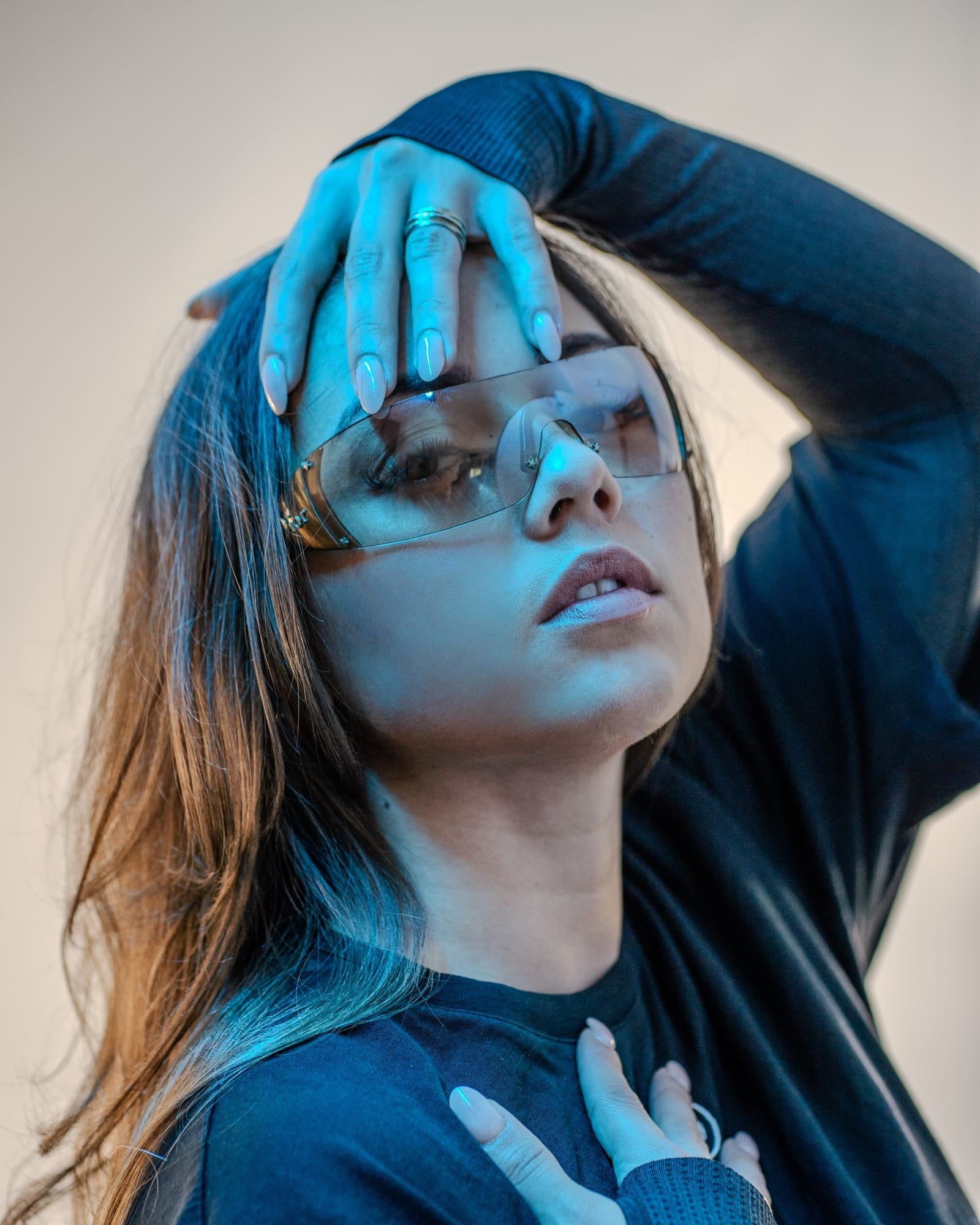 Beauty portrait with sunglasses in cool blue light