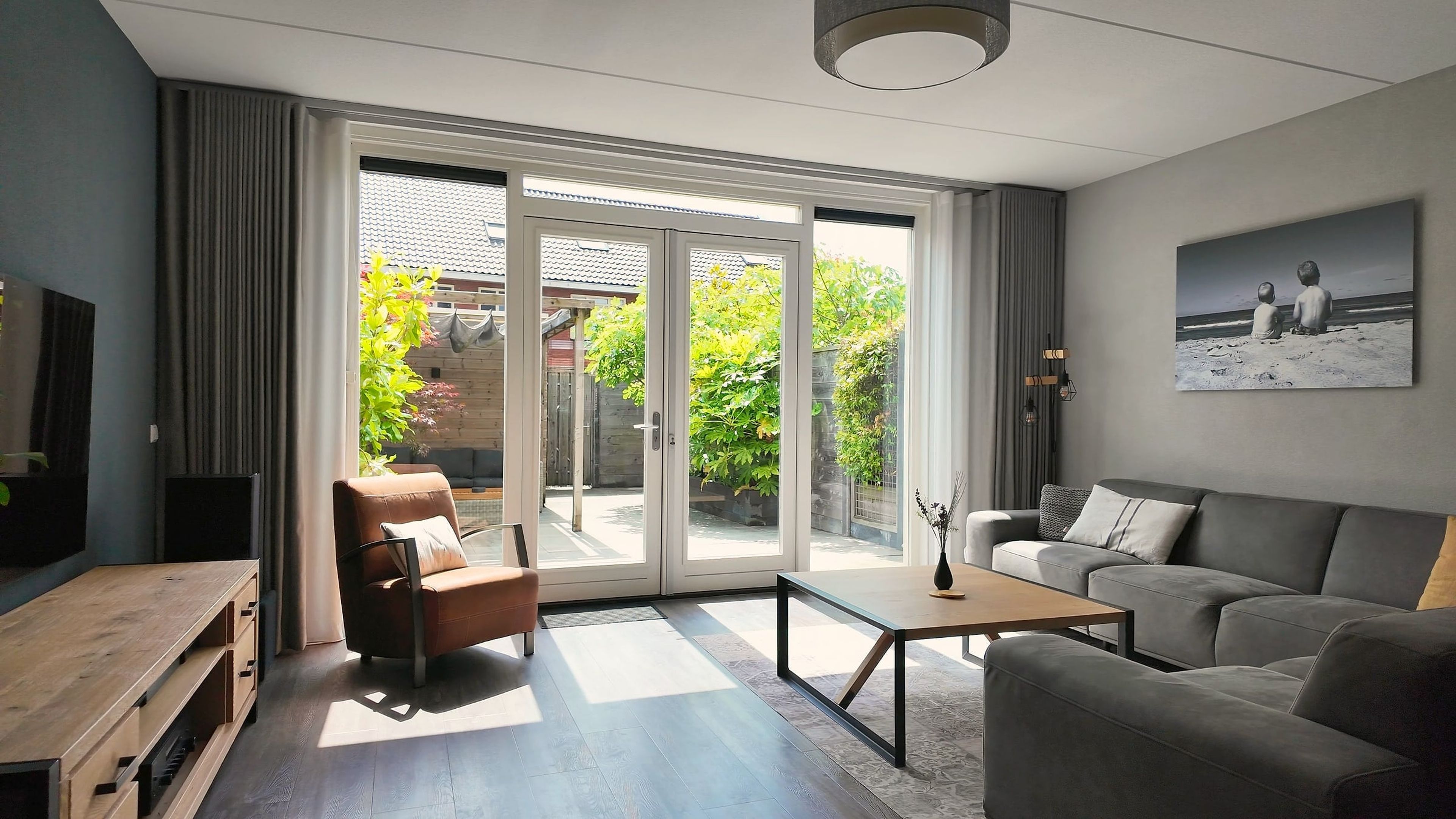 Bright living room with garden doors, photographed for a listing