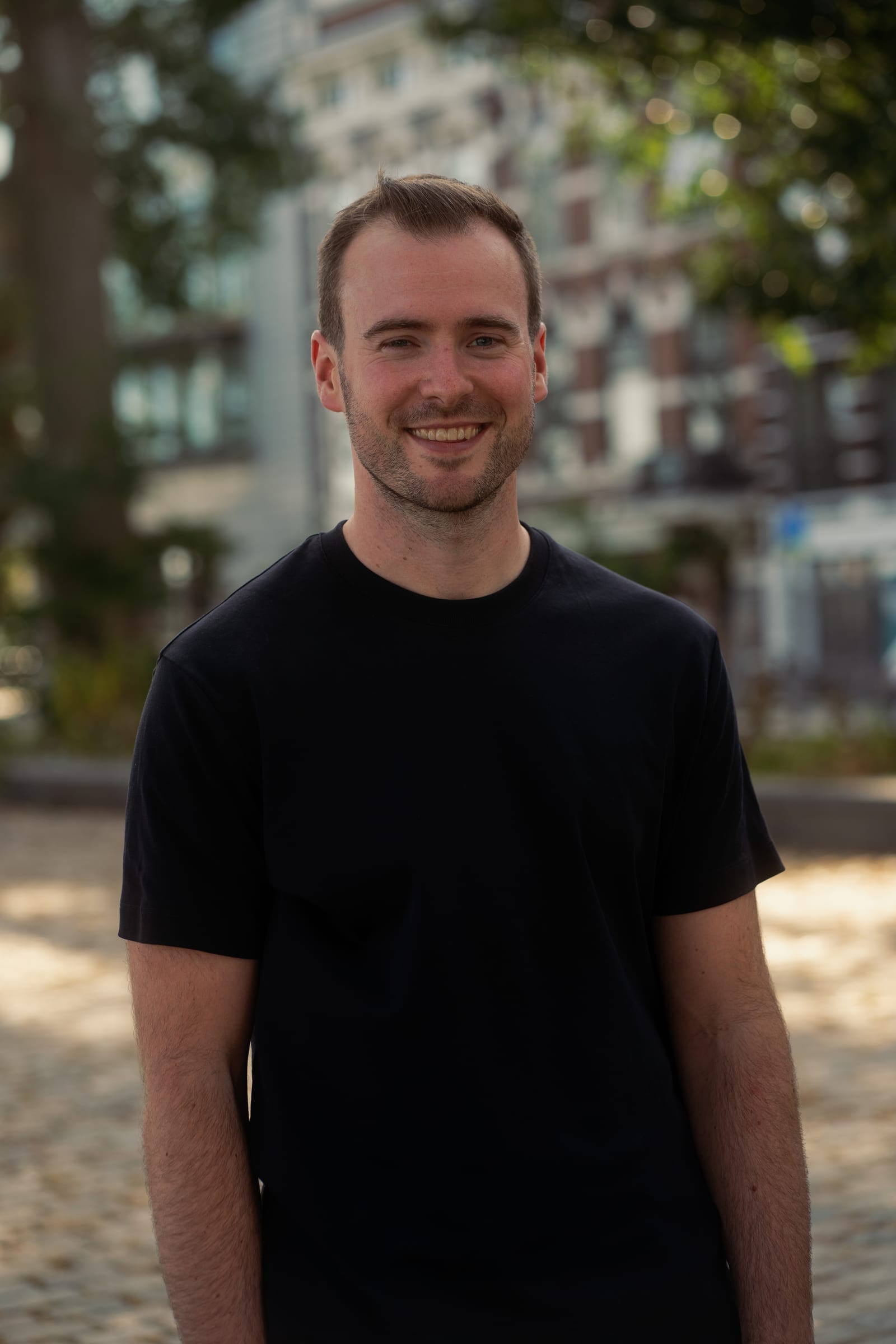 Smiling corporate portrait with the city in the background
