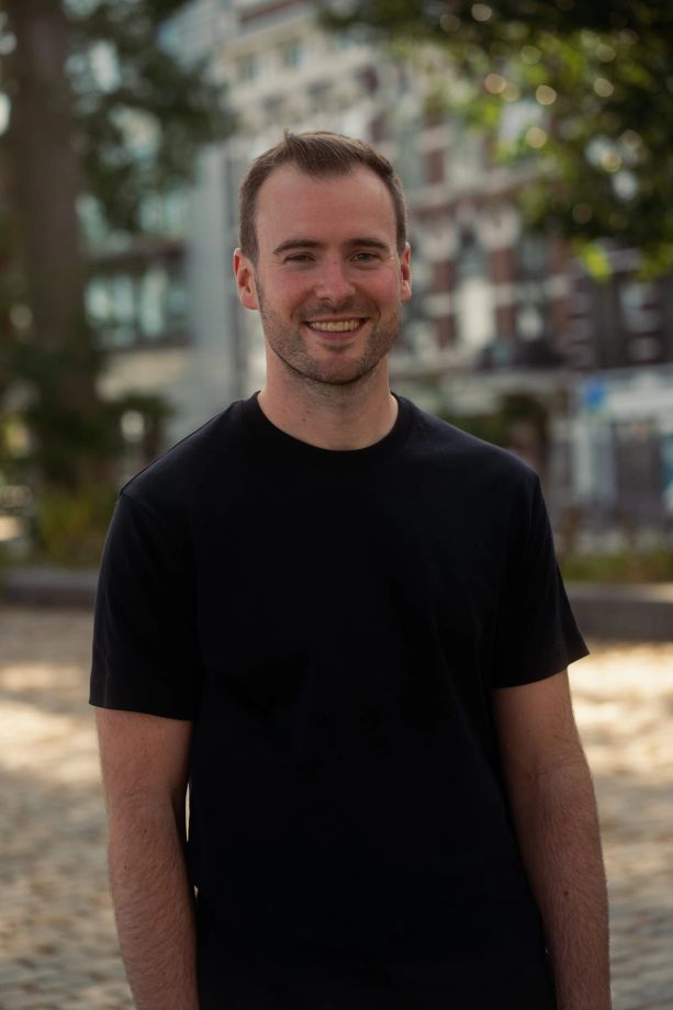 Smiling corporate portrait with the city in the background