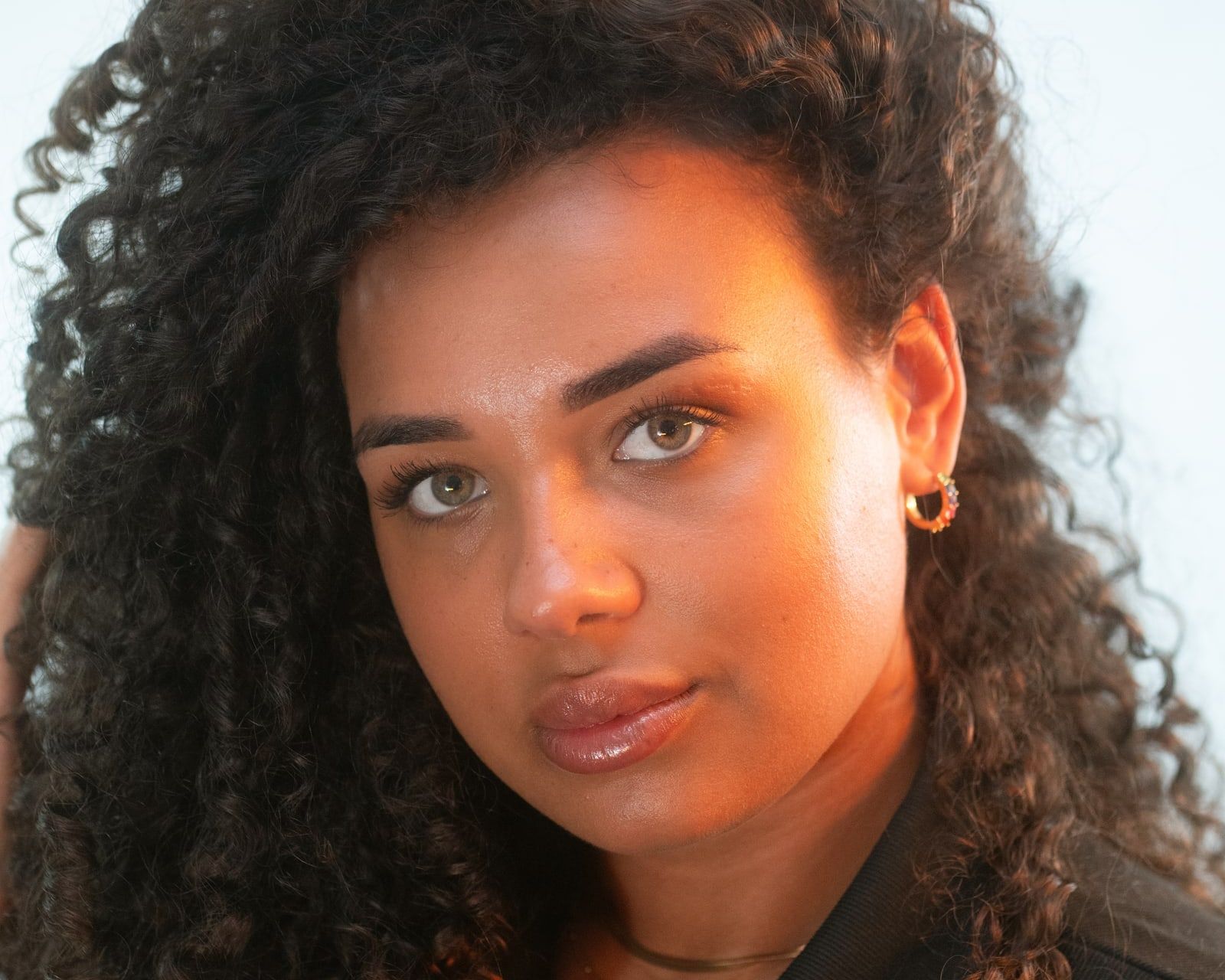 Close-up portrait with curls and gold earrings