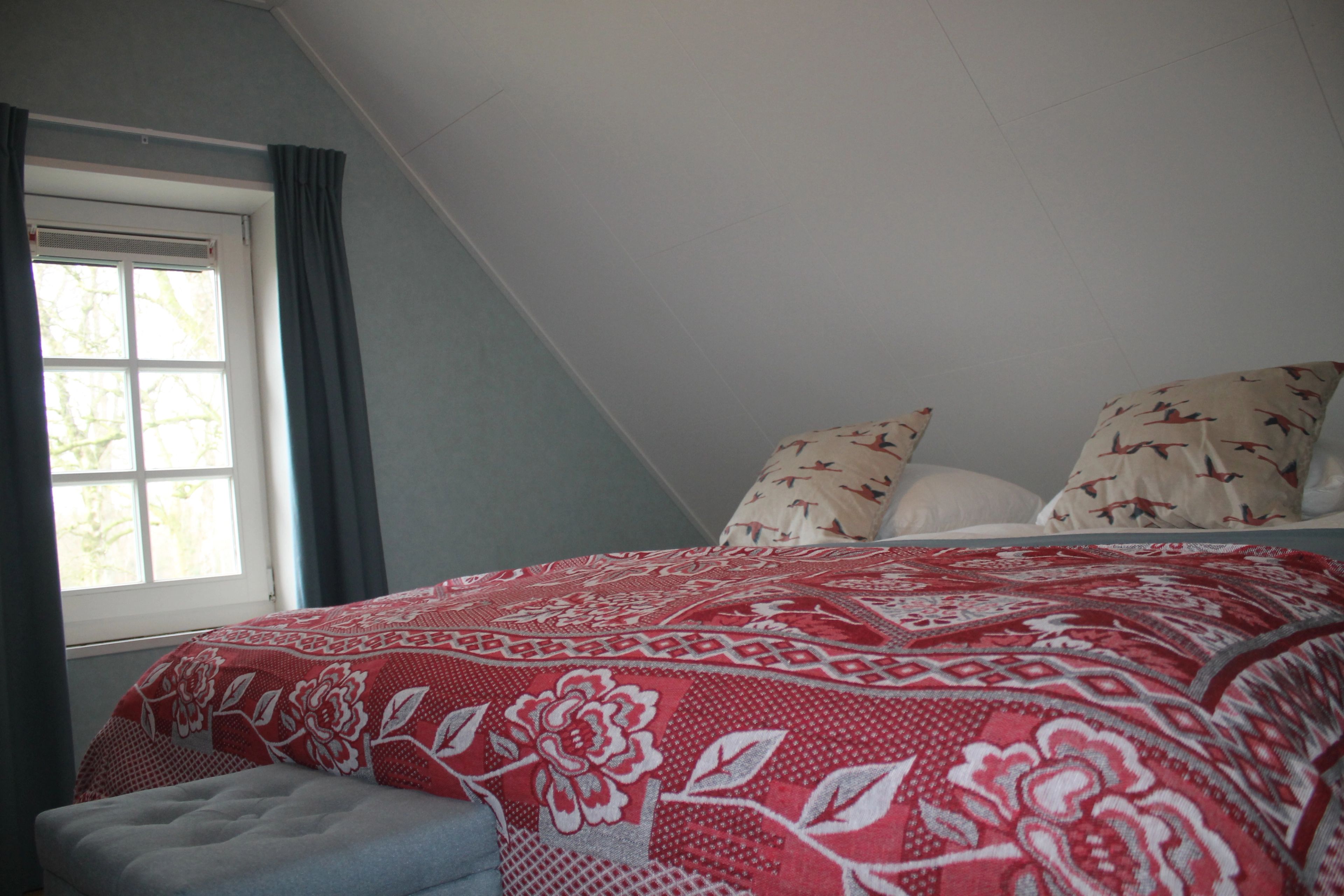 Made-up double bed in a holiday home