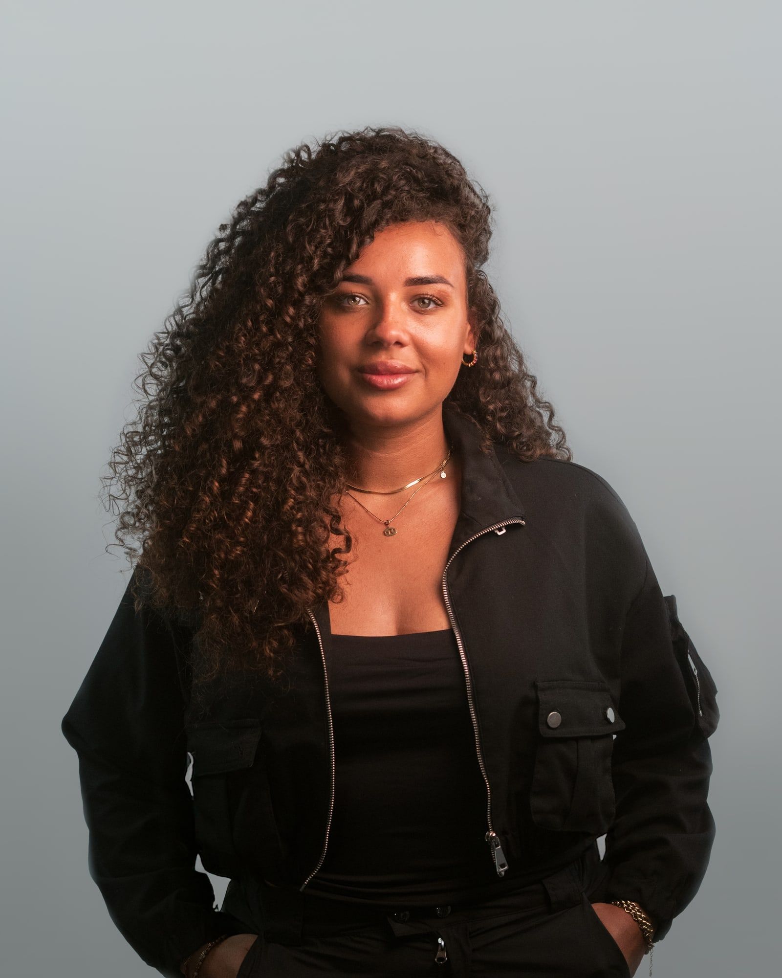 Personal branding portrait against a grey backdrop