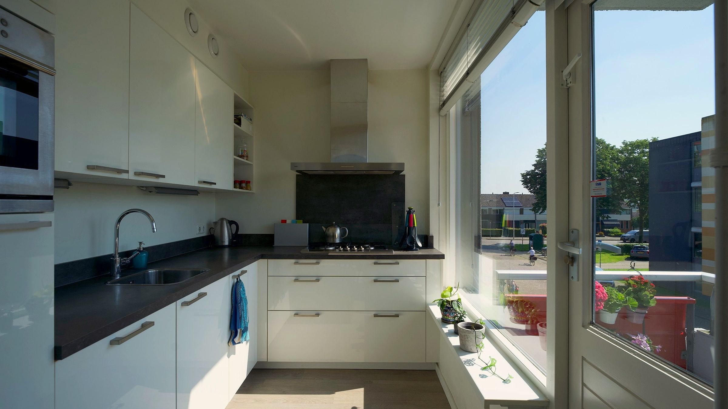 White kitchen with a door to the balcony