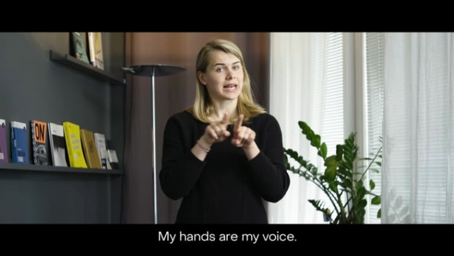 a woman gesturing hand-sign language
