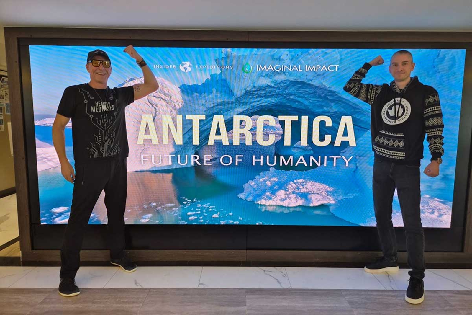 Dave and Bojan in front of Antarctica billboard
