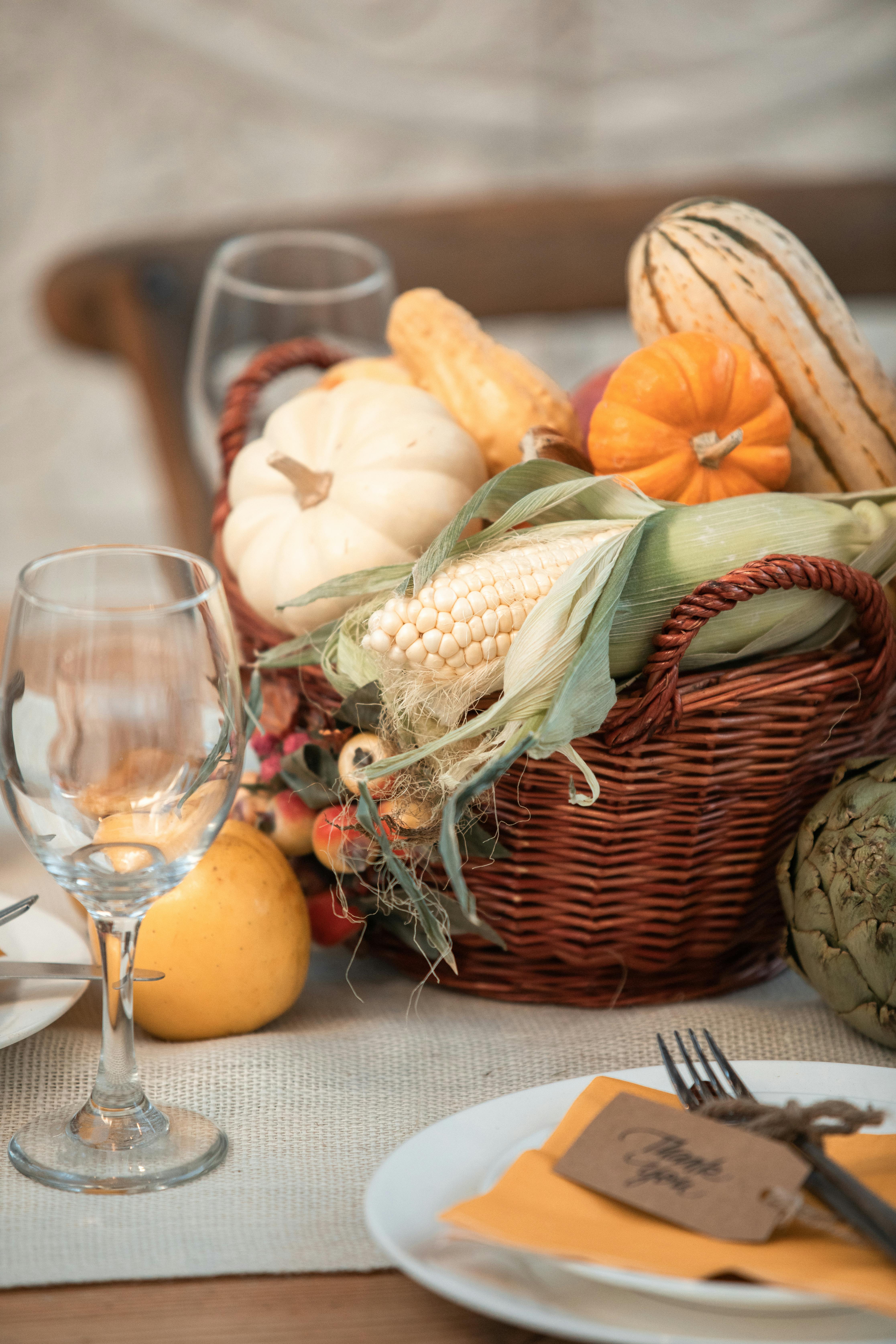 Cornucopia filled with squash and pumpkins, corn and other autumn vegetables 