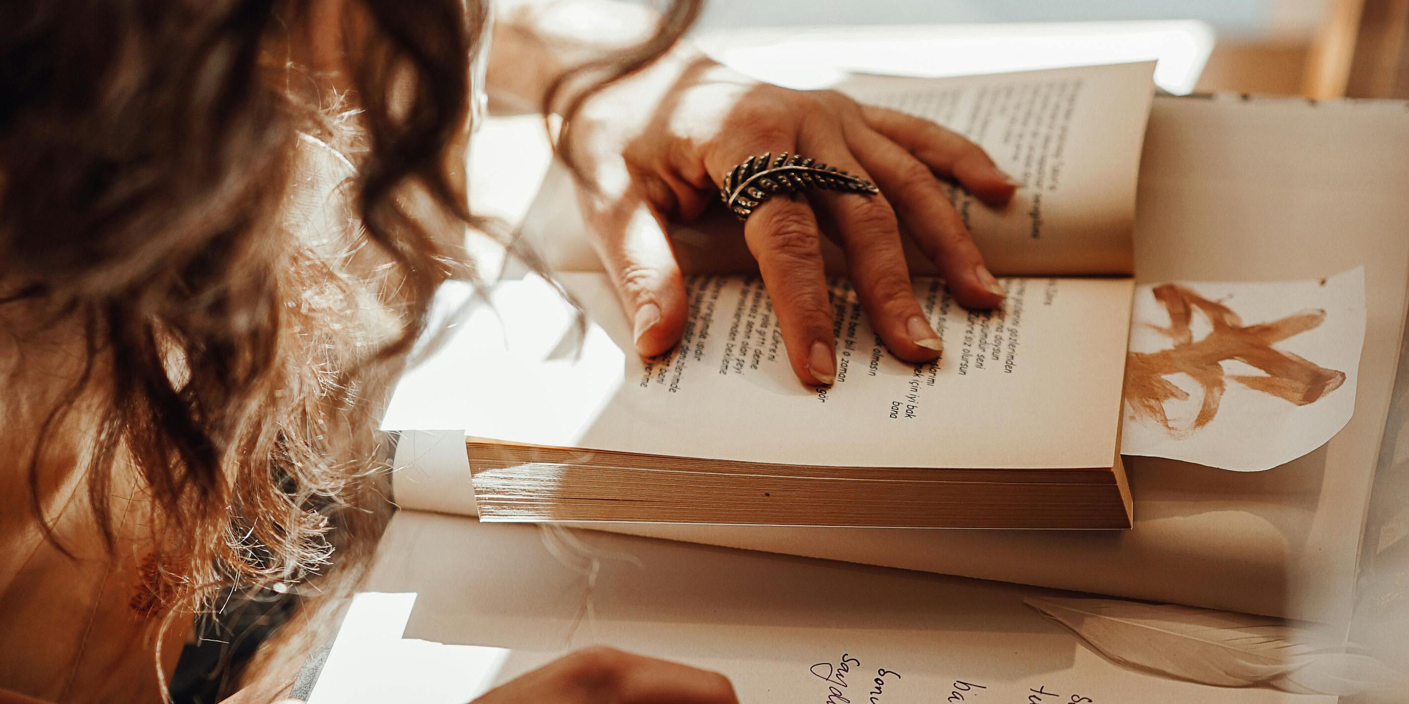 Woman reading a book and taking notes
