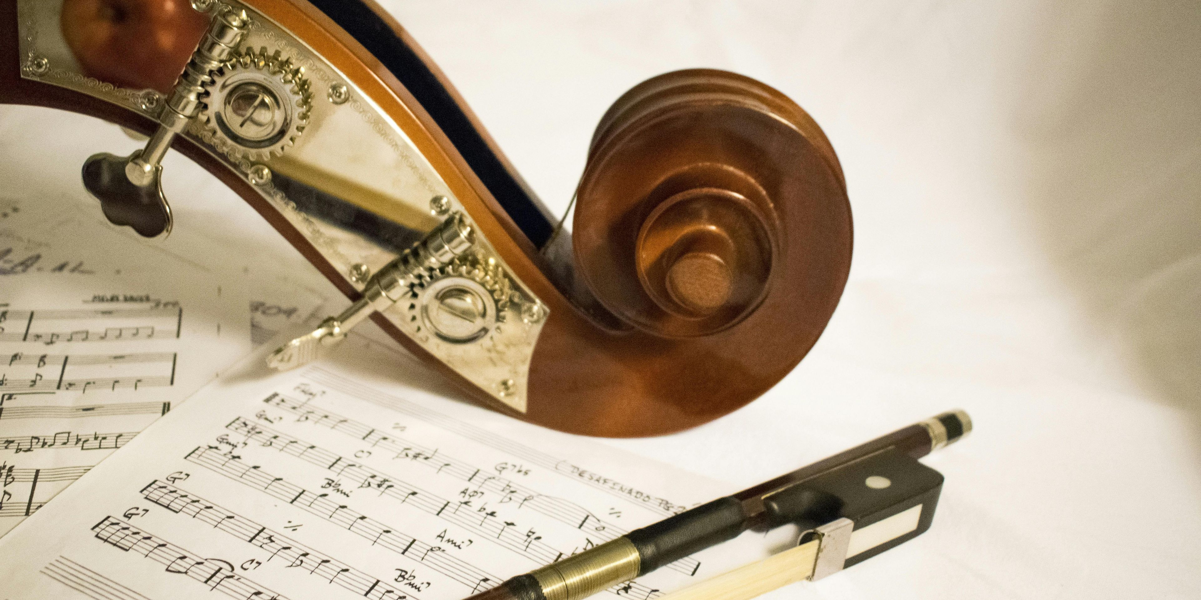 Violin and bow sitting on top of sheet music