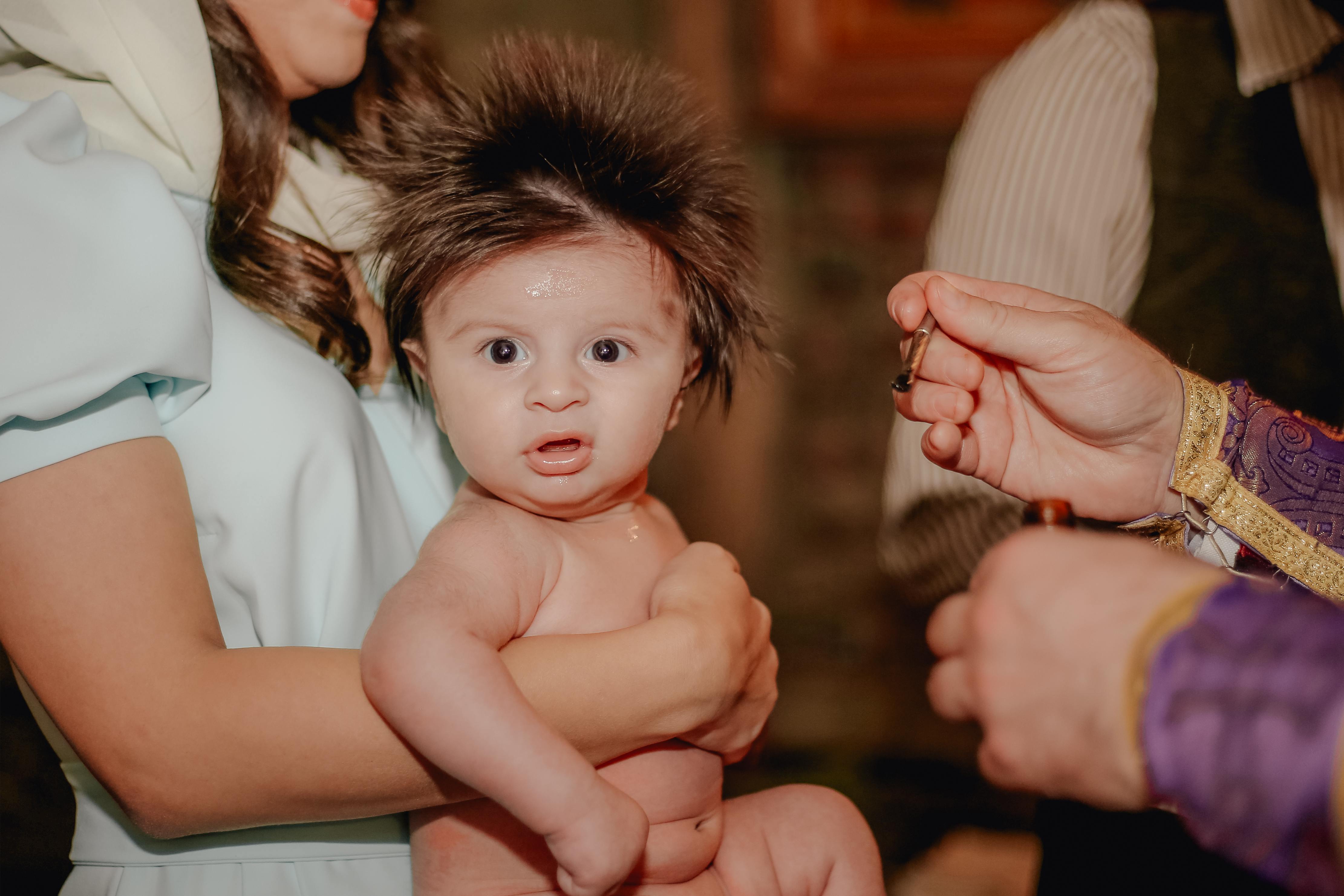 Crazy hair baby looking disgusted at the camera
