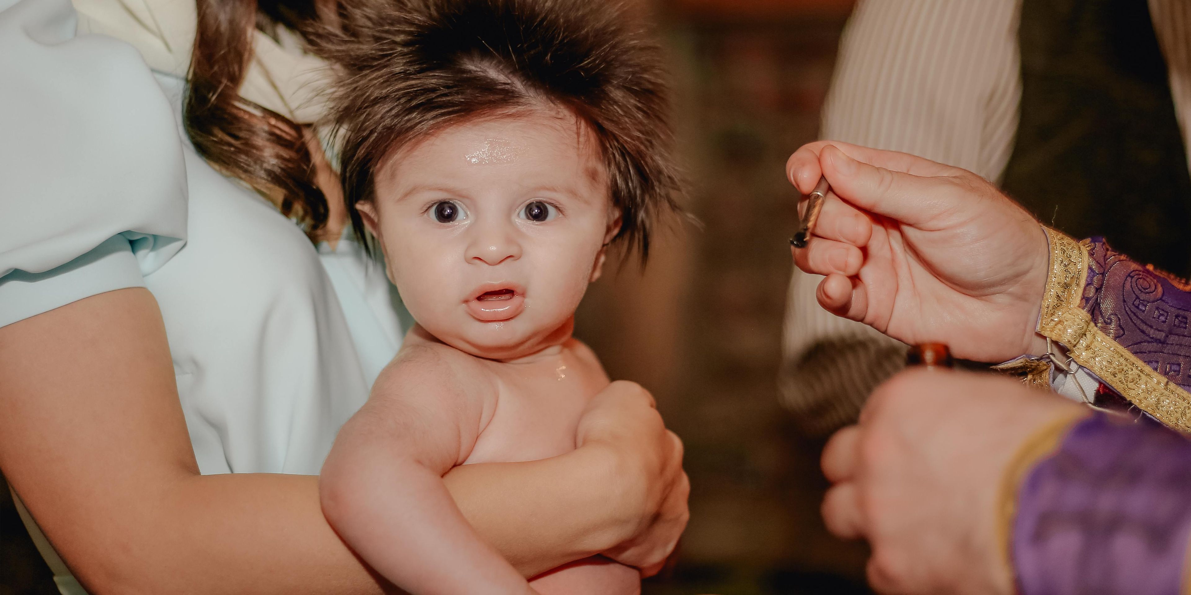 Crazy hair baby looking disgusted at the camera