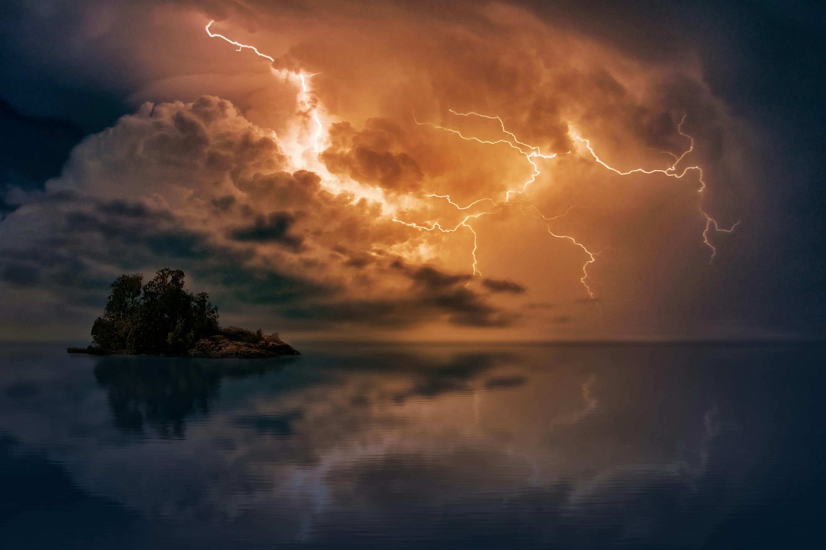 Lightning over water and a small island
