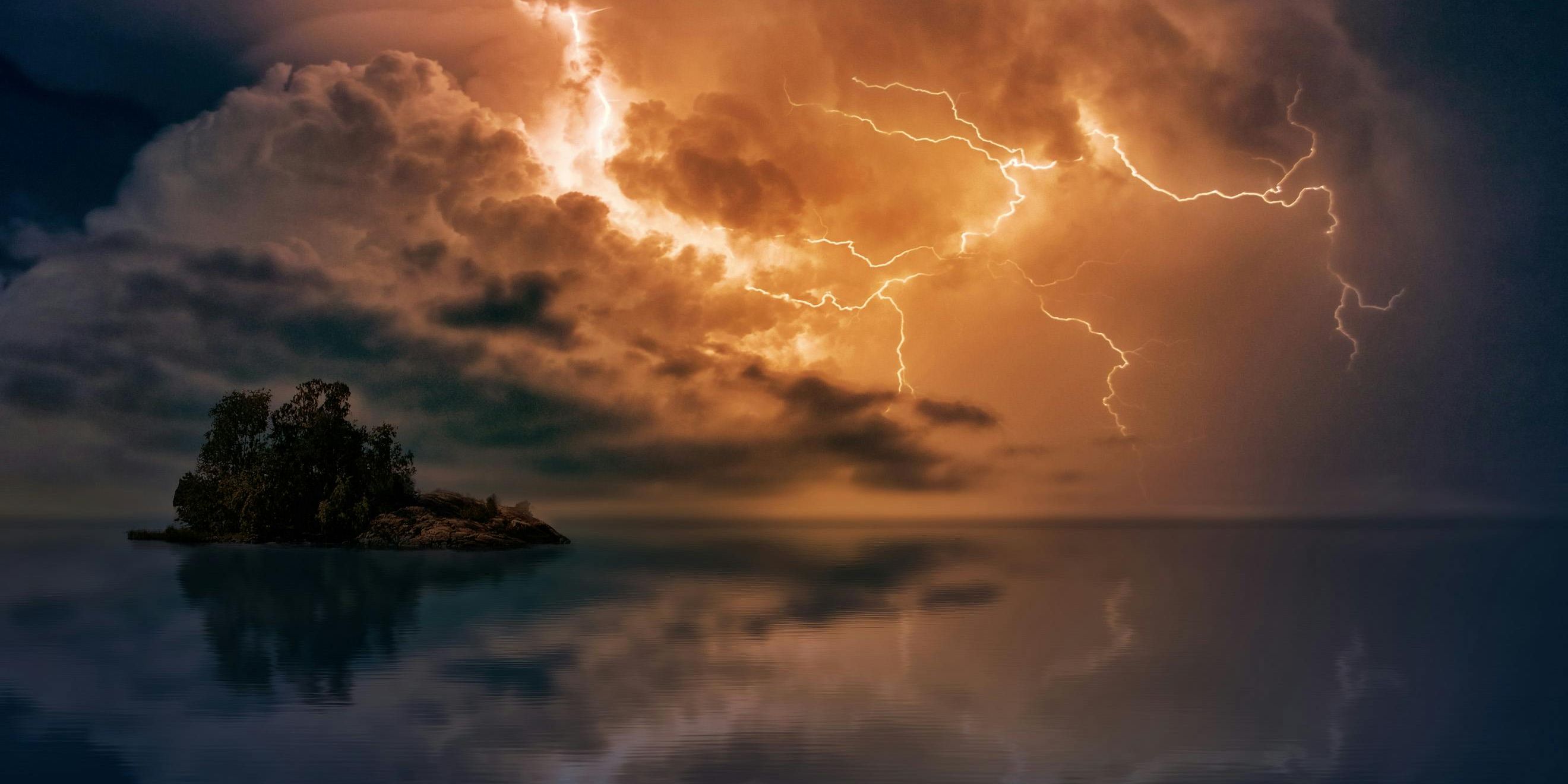 Lightning over water and a small island