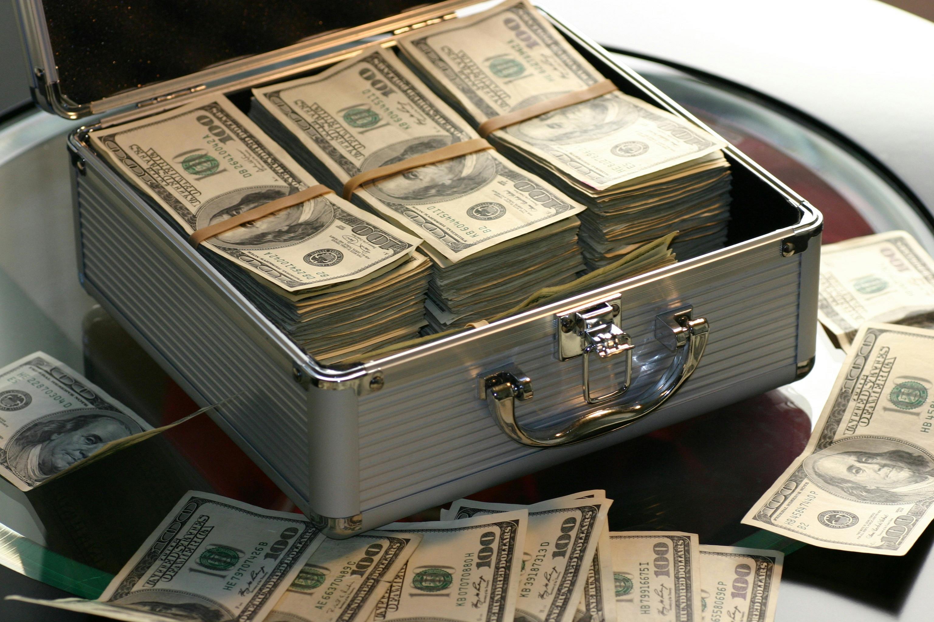 Briefcase overflowing with money