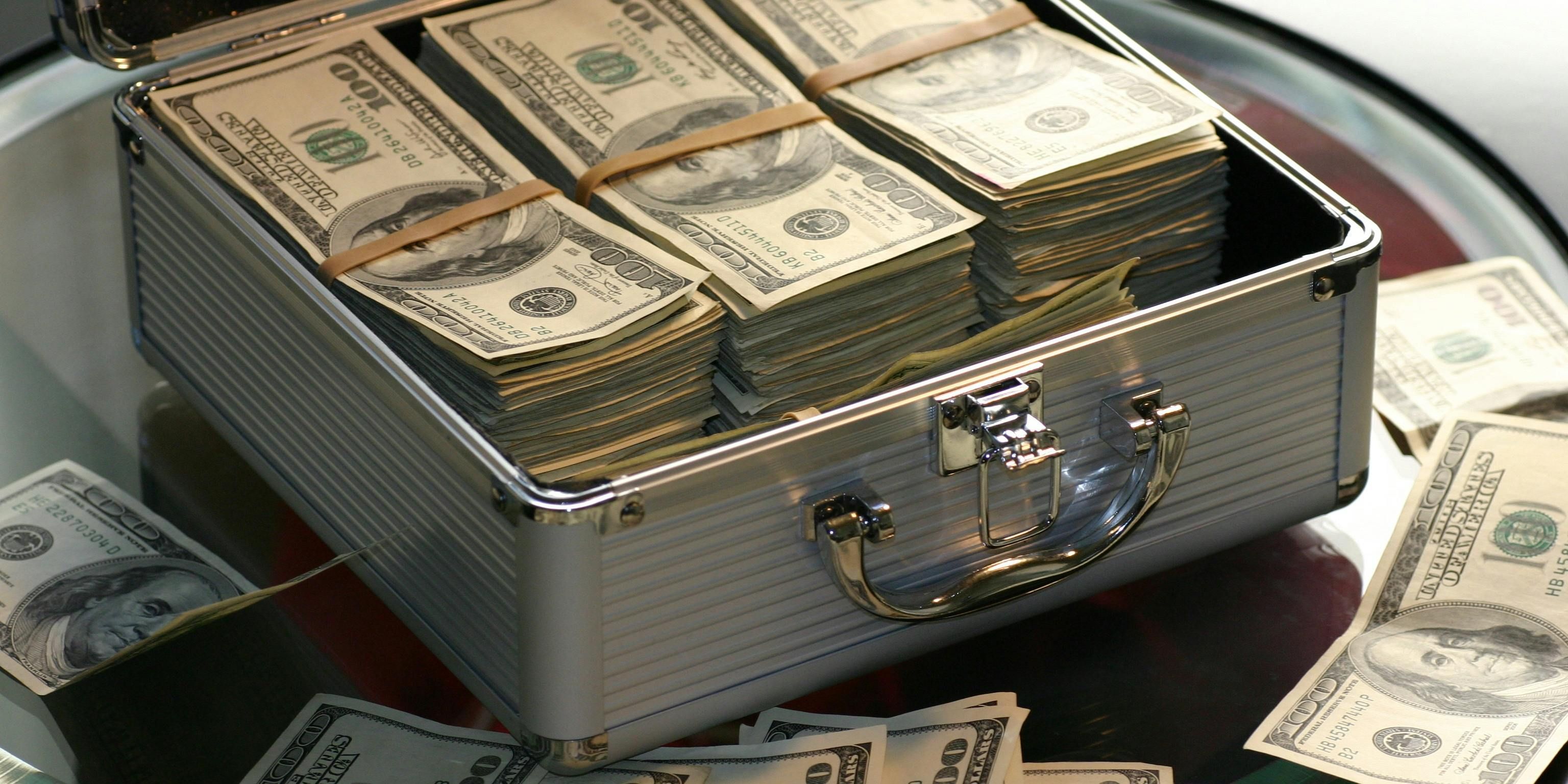 Briefcase overflowing with money