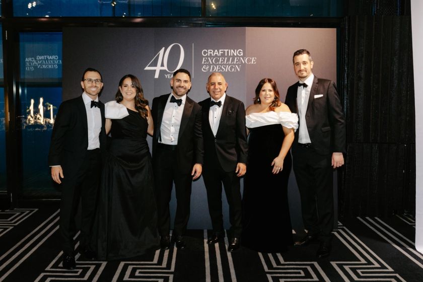 The Timpelle Kitchens team in black tie at the branded 40 Years anniversary backdrop in Sydney