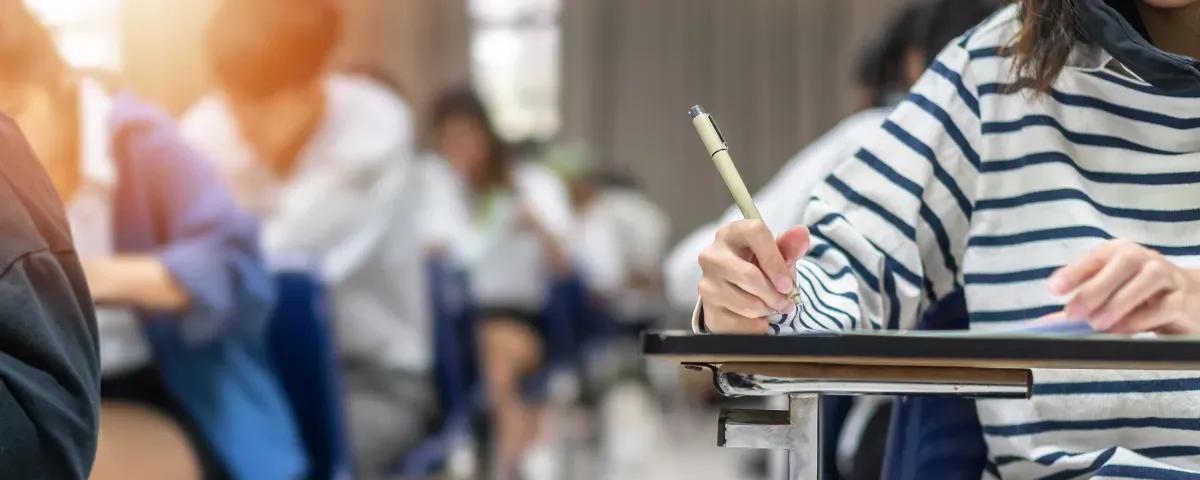 A group of students are taking a test in a classroom