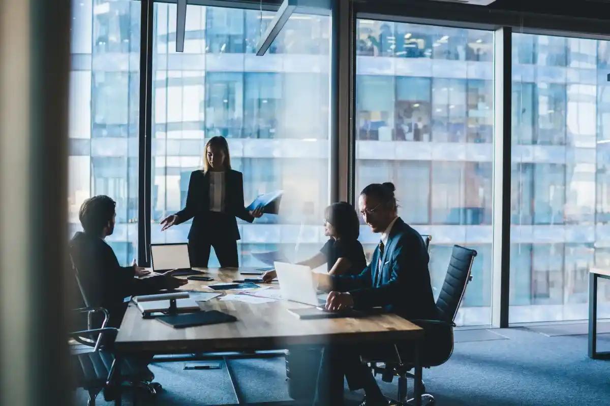 A group of business people are having a meeting in a conference room