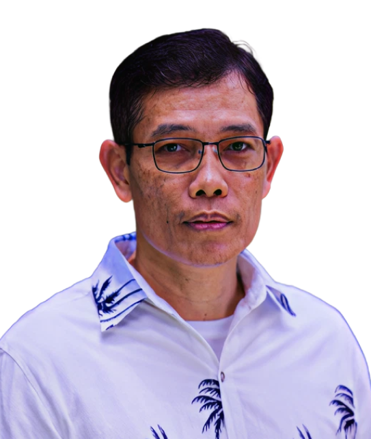 A man wearing glasses and a white shirt with palm trees on it