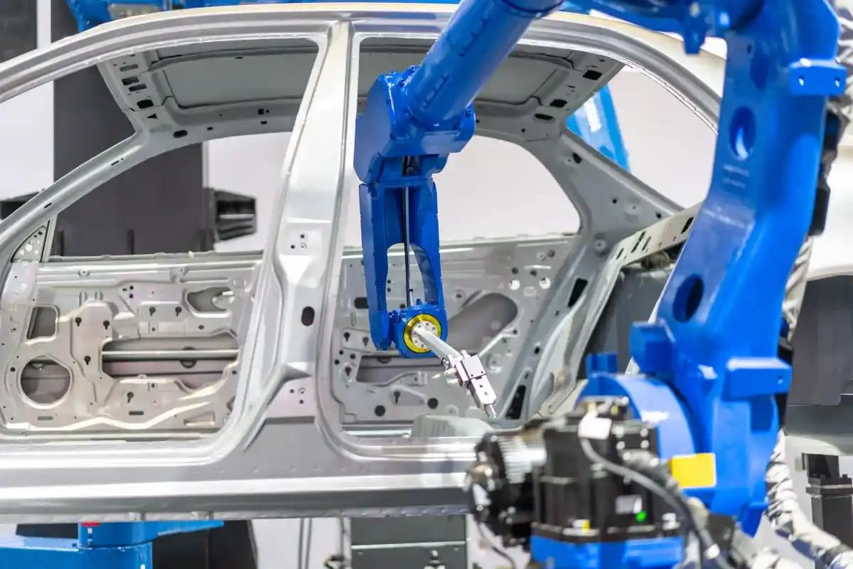 A robot is working on a car in a factory