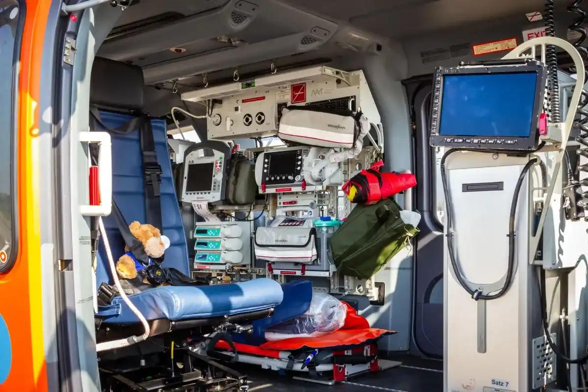 The inside of an ambulance with a bed and a monitor