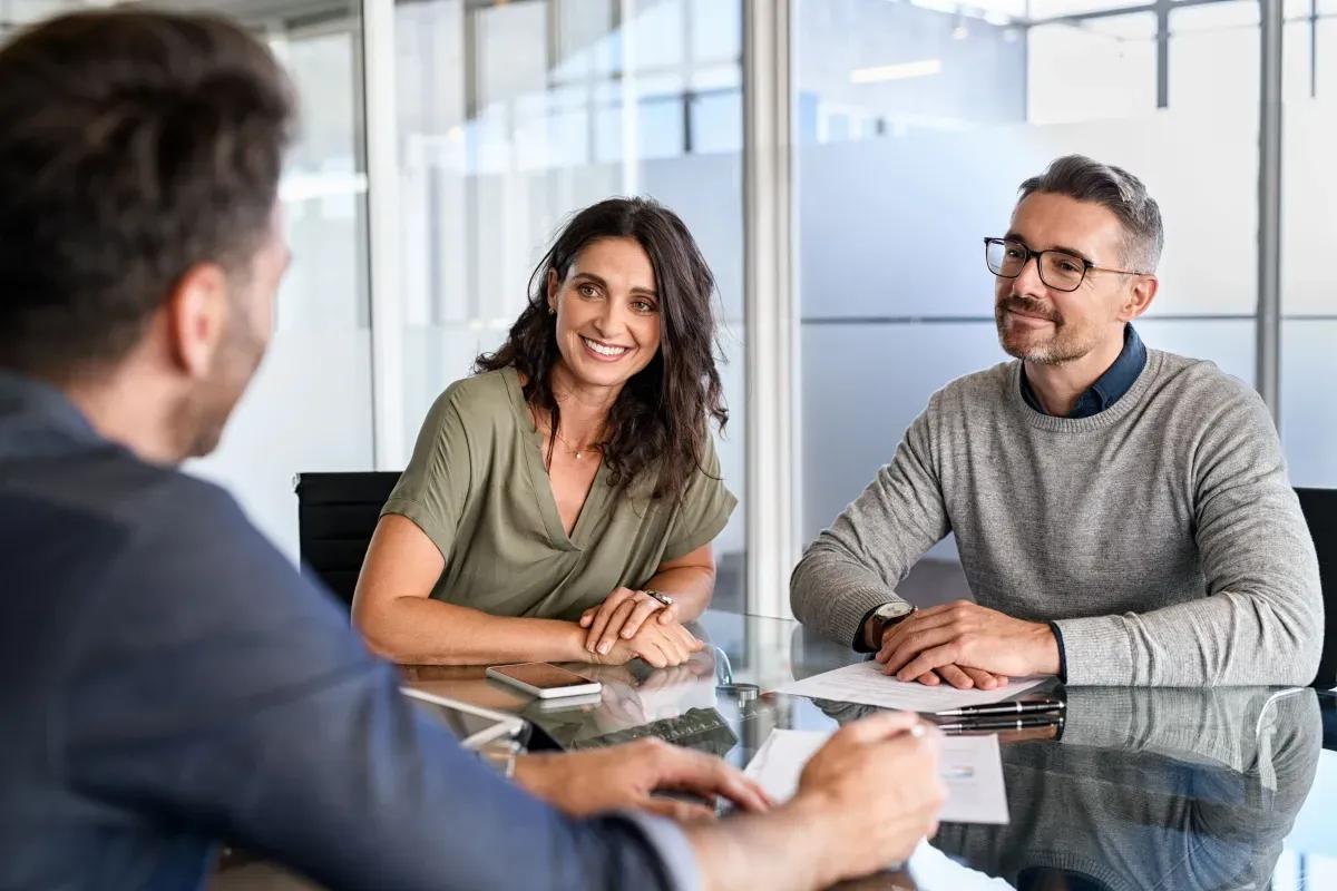 A man and a woman are sitting at a table talking to each other