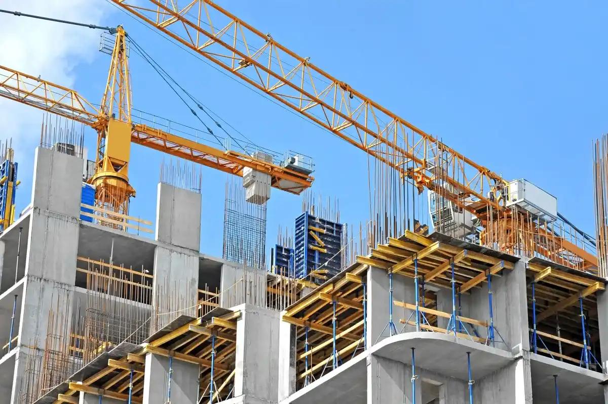 A large building is being built with a crane in the background