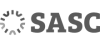 A black and white sasc logo on a black background