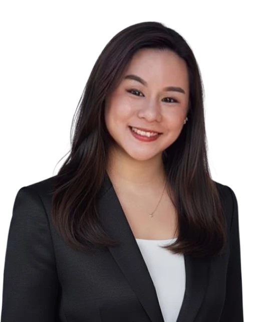 A woman in a black jacket and white shirt is smiling for the camera