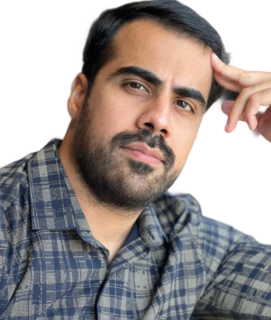 A man with a beard is wearing a plaid shirt