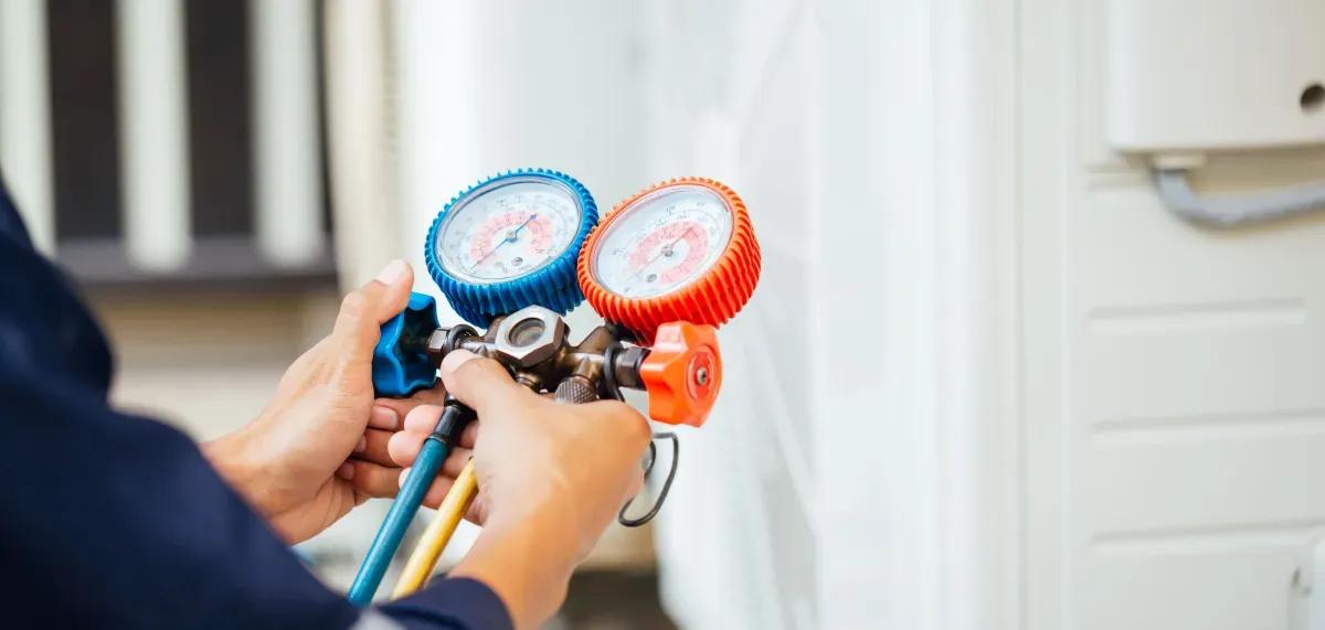 A man is holding a couple of gauges in his hands