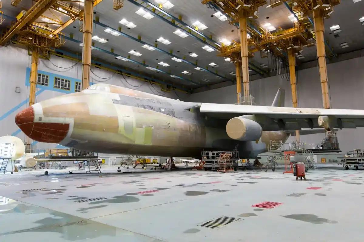 A large military plane is being built in a hangar