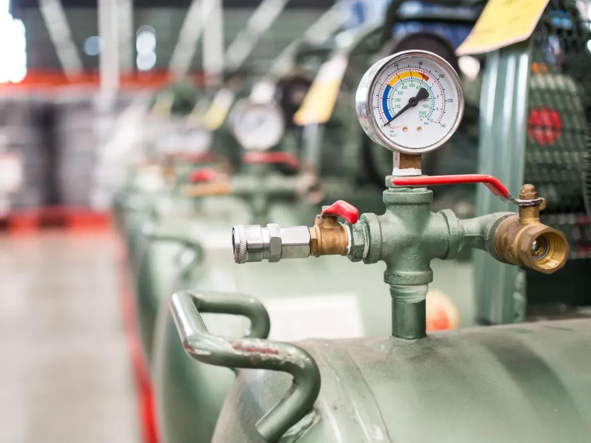 A close up of a pressure gauge on a machine in a factory