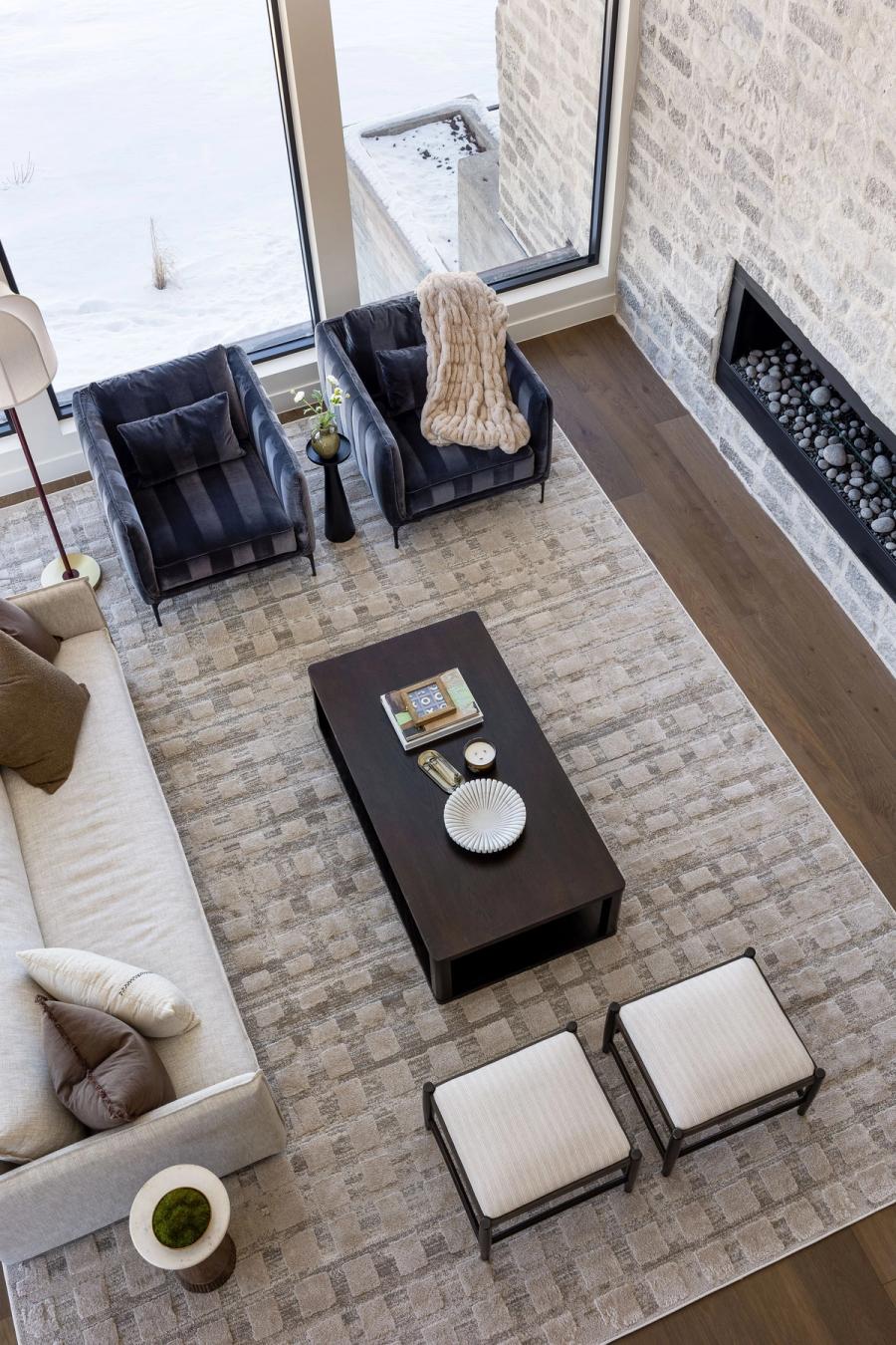 Looking down into the Harris Way great room — stone fireplace wall and layered seating by Jewkes Design