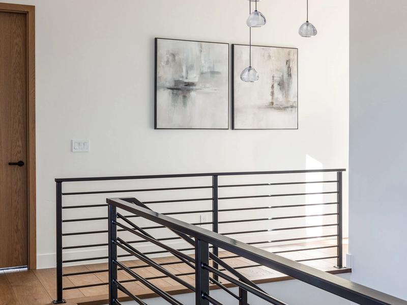 modern staircase black metal railing wood treads luxury home interior Benloch Ranch Park City area