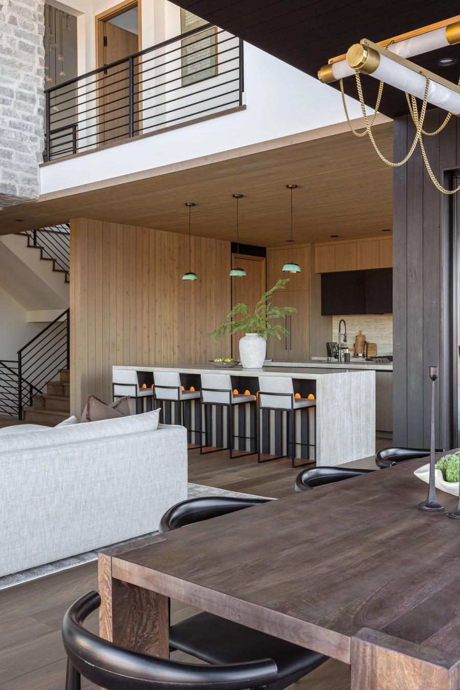 Harris Way great room and kitchen under a continuous wood ceiling, with the mezzanine above