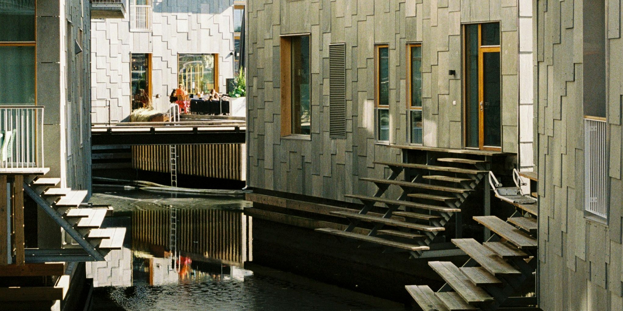 a row of buildings with stairs leading up to the water