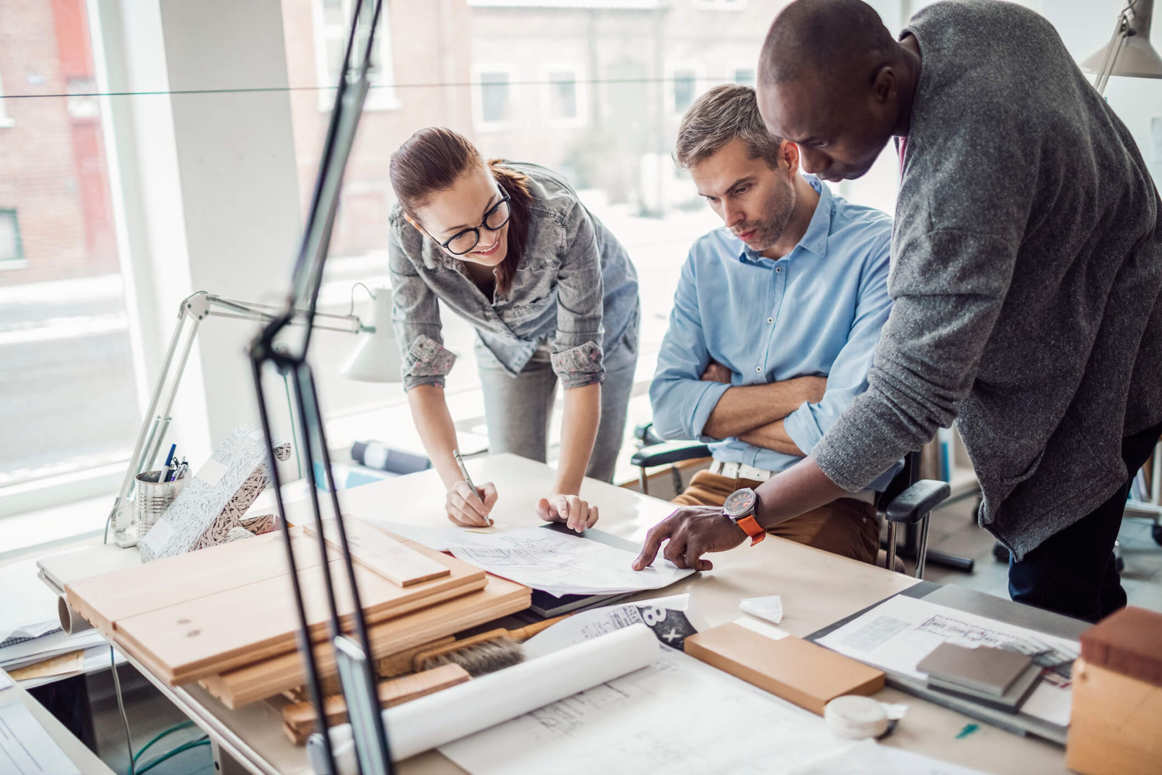 Team collaborating on a design project in a modern office